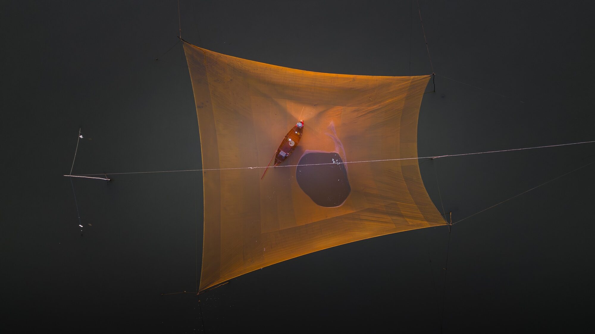 Fisherman lifting the net